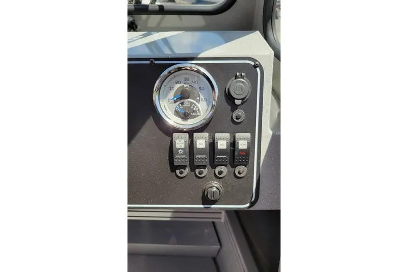 Slide: The Image of 2025 Smoker Craft Phantom 20 X2 OS dashboard with gauges and switches. - 18