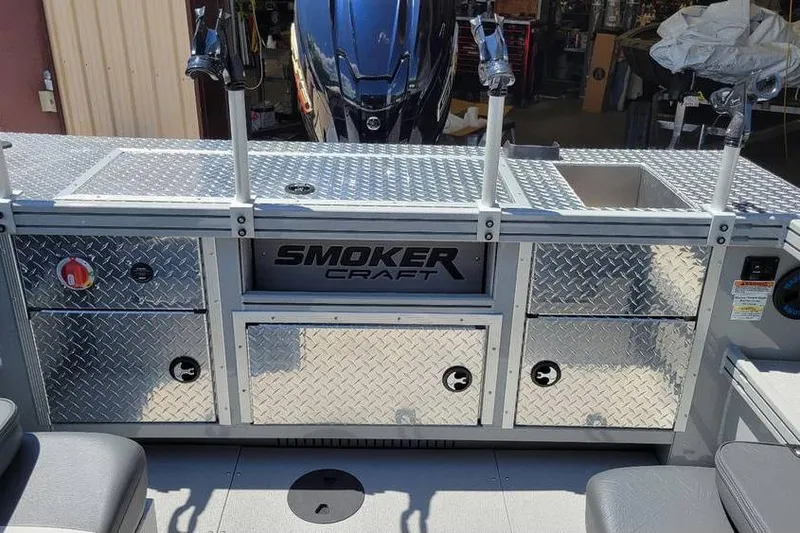 Slide: The Image of 2025 Smoker Craft Phantom 20 X2 OS boat with diamond plate storage and motor. - 23