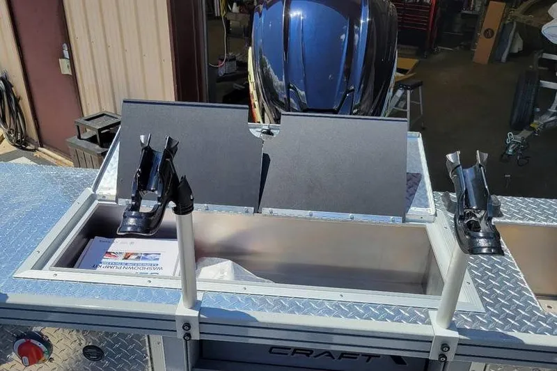 Slide: The Image of 2025 Smoker Craft Phantom 20 X2 OS boat with open storage compartment and rod holders. - 27