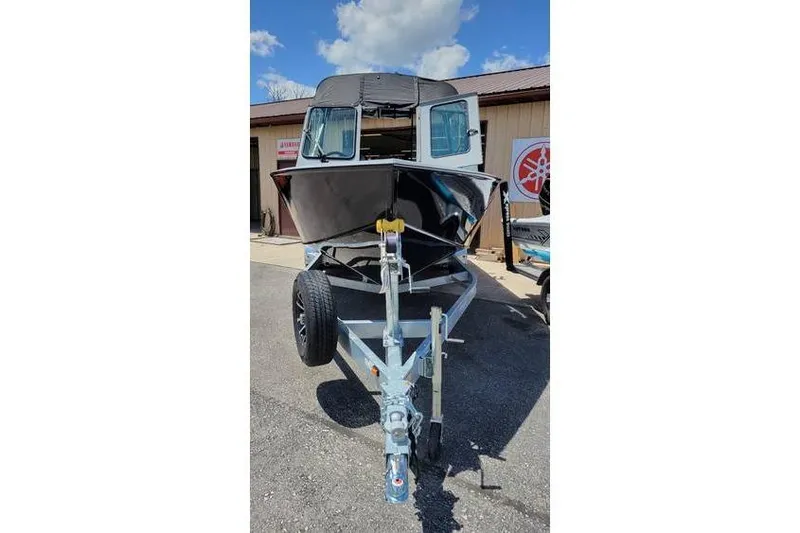 Slide: The Image of 2025 Smoker Craft Phantom 20 X2 OS boat on trailer, parked outdoors. - 7