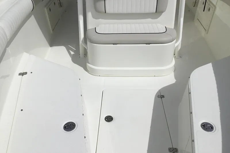 Slide: The Image of 2016 Mako 284 Center Console boat interior with seating and storage compartments. - 12