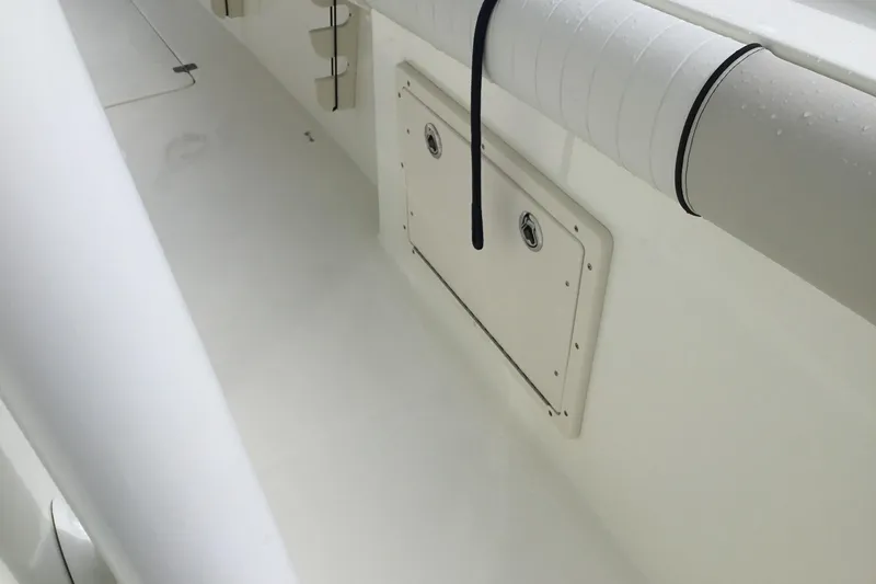 Slide: The Image of 2016 Mako 284 Center Console interior with rod holder and storage compartment. - 17