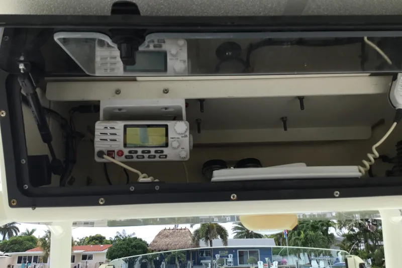 Slide: The Image of 2016 Mako 284 Center Console boat dashboard with radio and navigation equipment. - 18