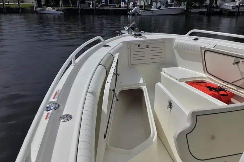 Slide: The Image of 2016 Mako 284 Center Console boat interior with storage compartments and seating. - 2