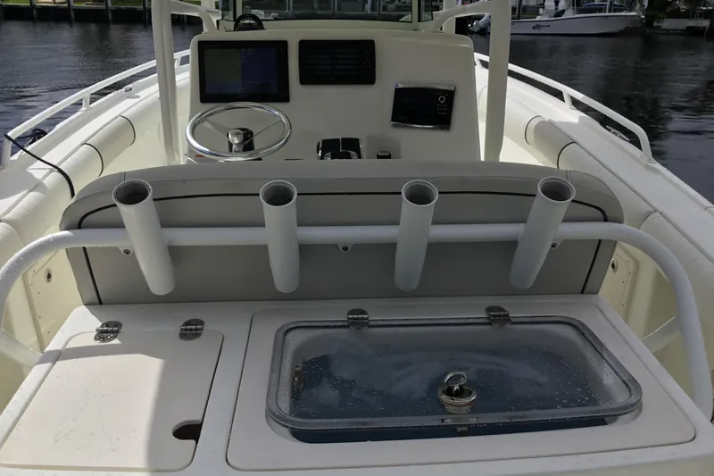 Slide: The Image of 2016 Mako 284 Center Console boat interior with rod holders and control panel. - 26