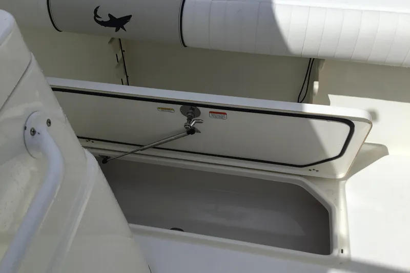Slide: The Image of 2016 Mako 284 Center Console boat storage compartment with open hatch. - 37