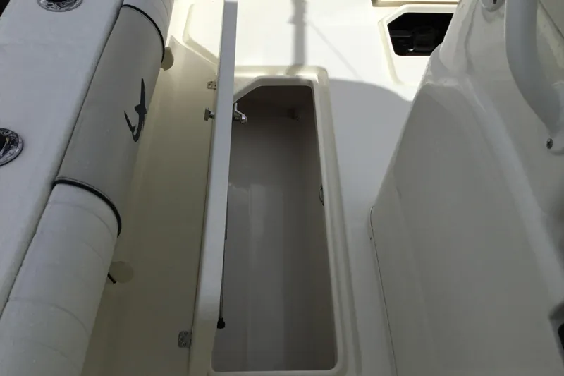 Slide: The Image of 2016 Mako 284 Center Console boat storage compartment open, showcasing interior space. - 38