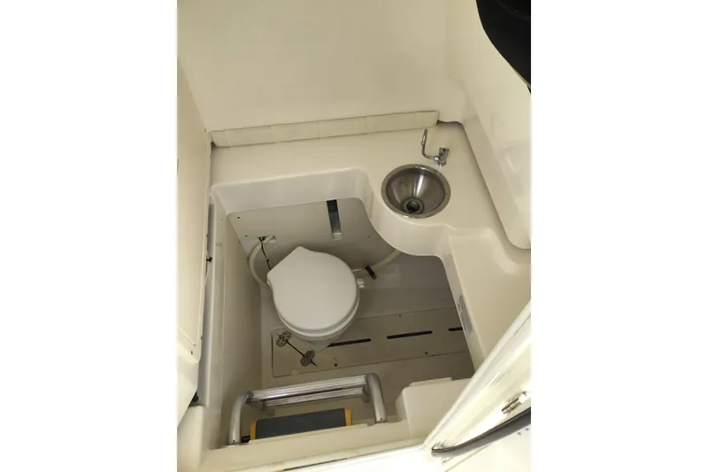 Slide: The Image of 2016 Mako 284 Center Console boat interior with toilet and sink. - 41