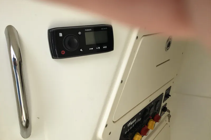 Slide: The Image of Control panel and audio system on a 2016 Mako 284 Center Console boat. - 44