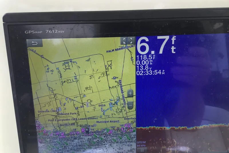 Slide: The Image of GPS display on a 2016 Mako 284 Center Console showing depth and map details. - 48