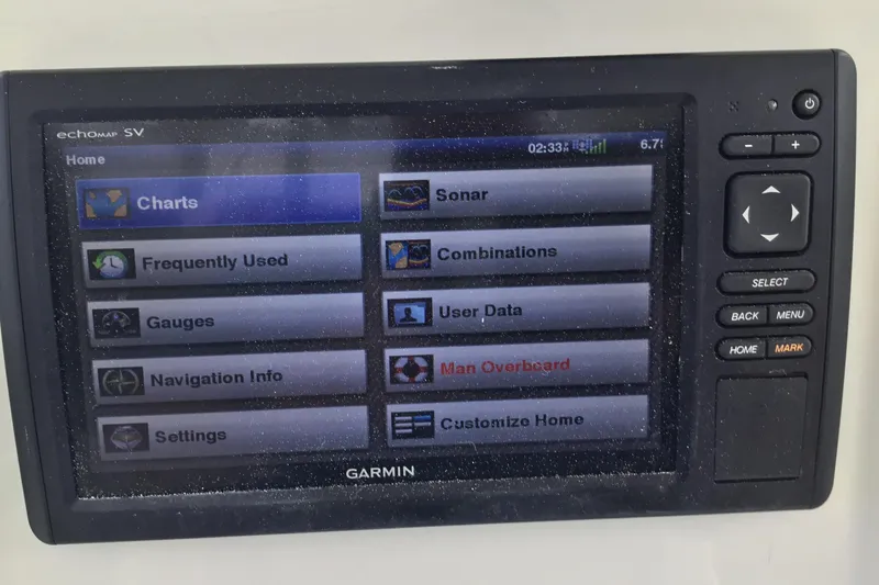 Slide: The Image of Garmin marine GPS display on 2016 Mako 284 Center Console boat, showing navigation options. - 49