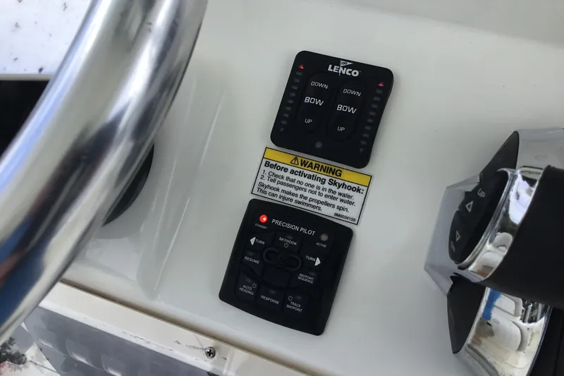 Slide: The Image of Control panel of a 2016 Mako 284 Center Console boat with steering wheel and warning label. - 51