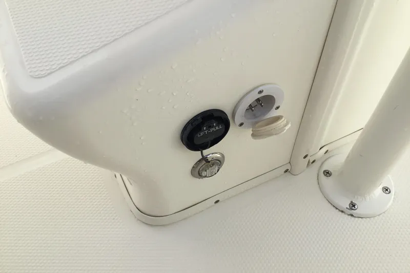 Slide: The Image of 2016 Mako 284 Center Console boat console with electrical outlet and key slot. - 55