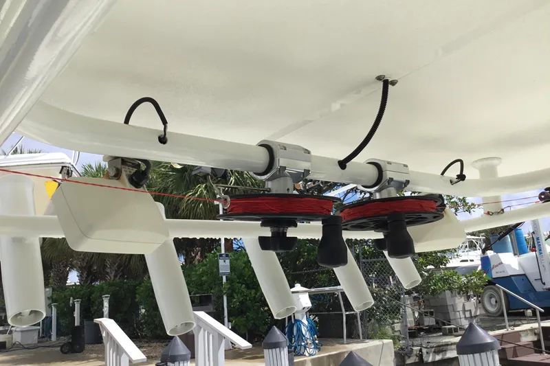 Slide: The Image of 2016 Mako 284 Center Console boat with fishing rod holders and equipment. - 57