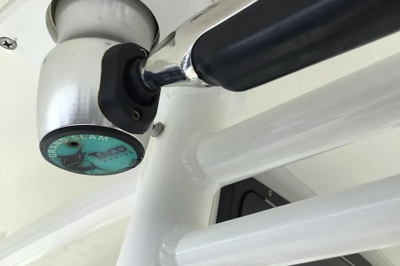 Slide: The Image of Close-up of a 2016 Mako 284 Center Console boat's T-top mount. - 59