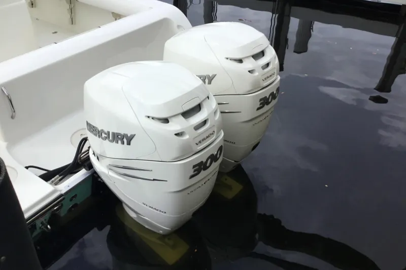 Slide: The Image of Twin Mercury 300 outboard engines on a 2016 Mako 284 Center Console boat. - 60