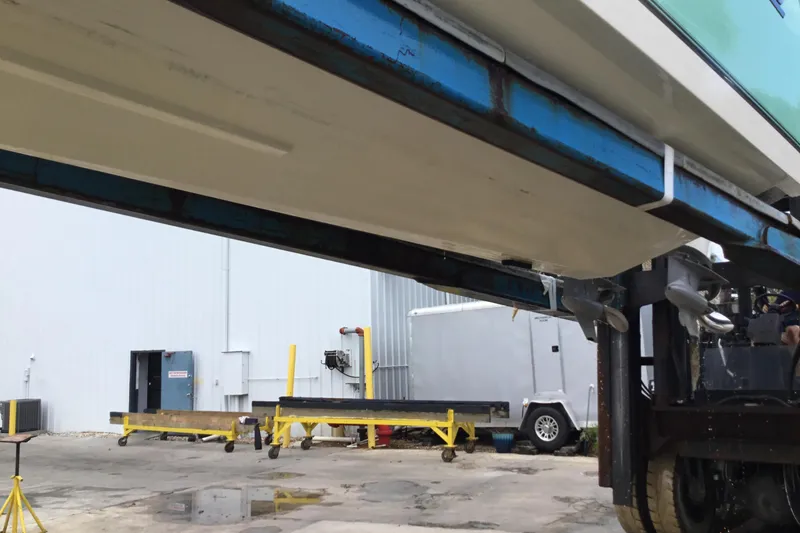 Slide: The Image of 2016 Mako 284 Center Console boat on a lift in a boatyard. - 79