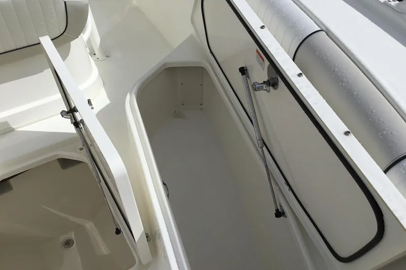Slide: The Image of Open storage compartment on a 2016 Mako 284 Center Console boat. - 8