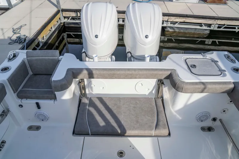 Slide: The Image of 2026 Sea Hunt Gamefish 28 boat with forward seating and dual engines at dock. - 11