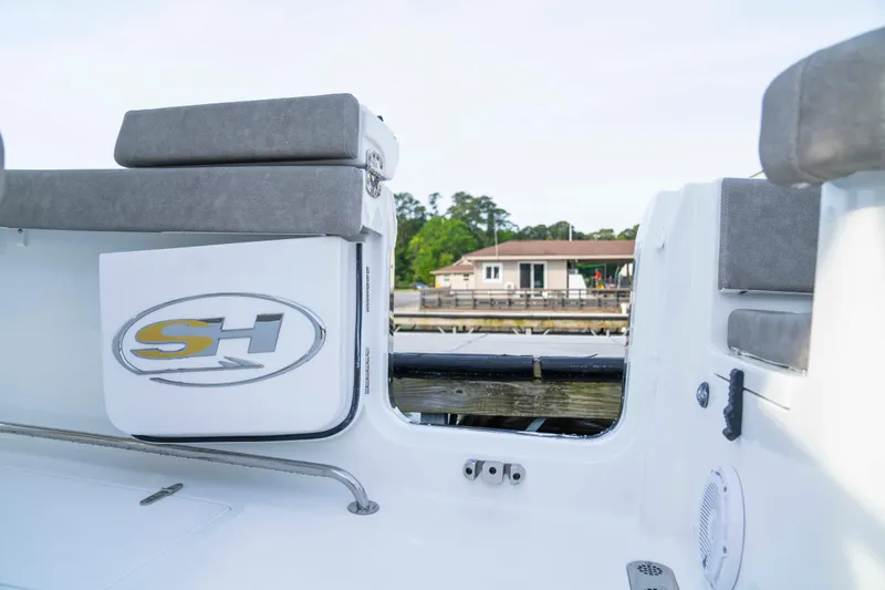 Slide: The Image of 2026 Sea Hunt Gamefish 28 Forward Seating boat interior with logo and cushioned seating. - 13