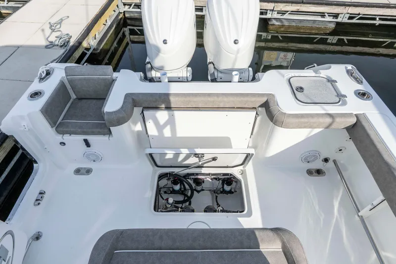 Slide: The Image of 2026 Sea Hunt Gamefish 28 Forward Seating boat interior with dual engines and seating area. - 14
