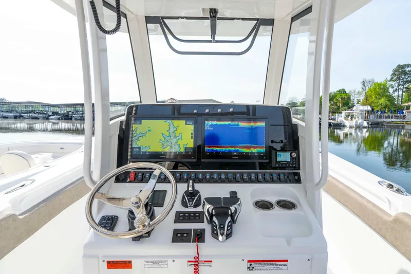 Slide: The Image of 2026 Sea Hunt Gamefish 28 helm with advanced navigation displays and controls. - 17