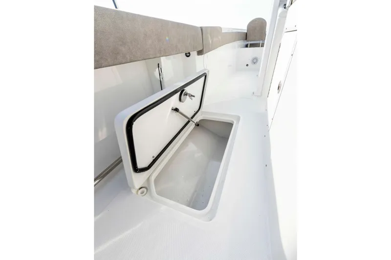 Slide: The Image of 2026 Sea Hunt Gamefish 28 Forward Seating storage compartment, open hatch, white interior. - 18
