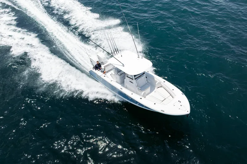 Slide: The Image of 2026 Sea Hunt Gamefish 28 boat cruising on open water, aerial view. - 23