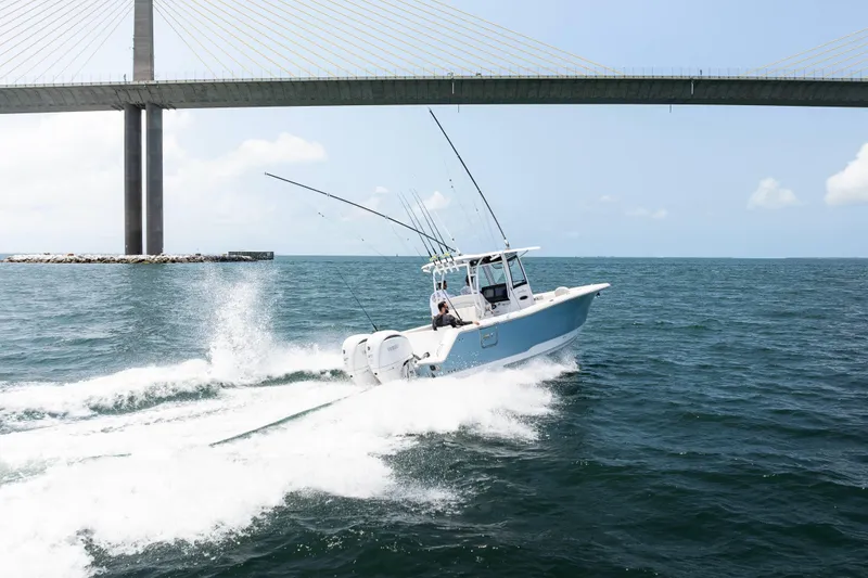 Slide: The Image of 2026 Sea Hunt Gamefish 28 cruising under a bridge on open water. - 24
