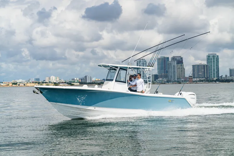 Slide: The Image of 2026 Sea Hunt Gamefish 28 cruising on water with city skyline in background. - 27