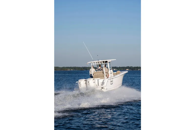 Slide: The Image of 2026 Sea Hunt Gamefish 28 Forward Seating boat cruising on open water. - 7