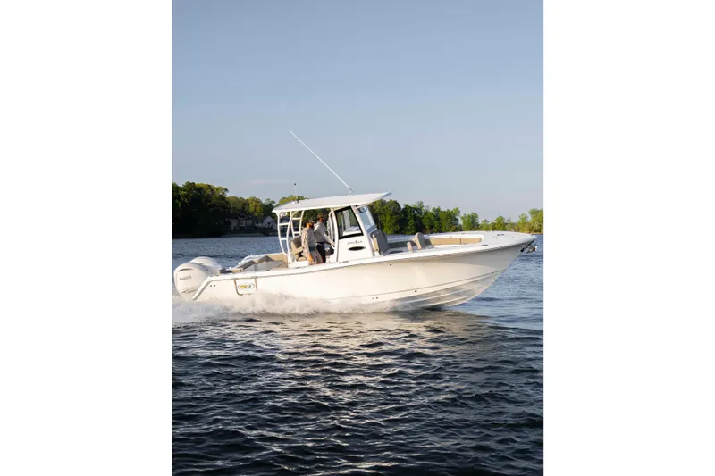 Slide: The Image of 2026 Sea Hunt Gamefish 28 Forward Seating boat cruising on a calm lake. - 9