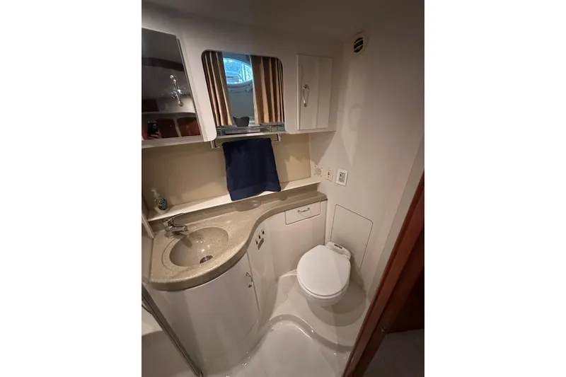 Slide: The Image of Bathroom interior of 2005 Carver 41 Cockpit Motor Yacht, featuring sink and toilet. - 11