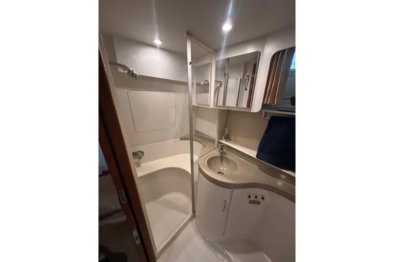 Slide: The Image of Bathroom interior of 2005 Carver 41 Cockpit Motor Yacht, featuring shower and vanity. - 12
