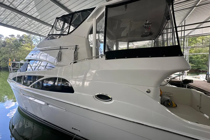 Slide: The Image of 2005 Carver 41 Cockpit Motor Yacht docked under a covered marina. - 2