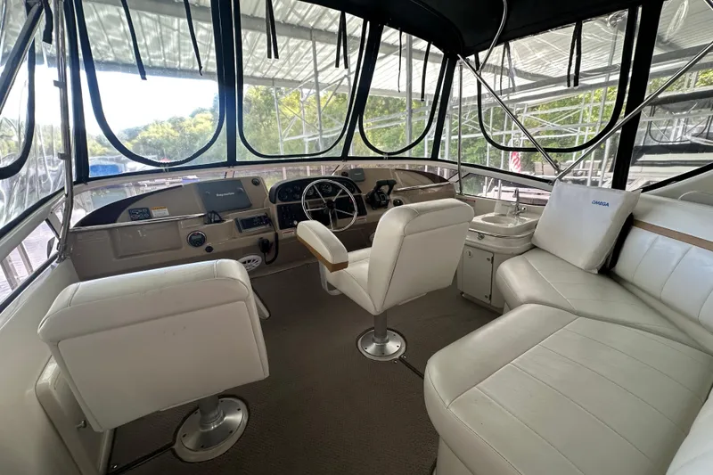 Slide: The Image of 2005 Carver 41 Cockpit Motor Yacht interior with helm, seating, and panoramic windows. - 15