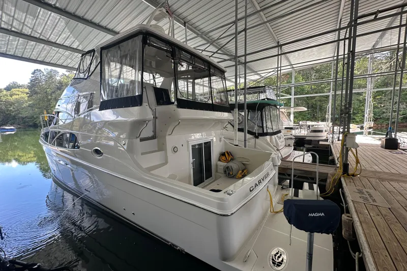 Slide: The Image of 2005 Carver 41 Cockpit Motor Yacht docked in a covered marina. - 3