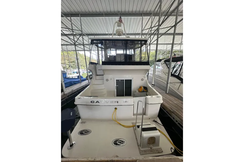 Slide: The Image of 2005 Carver 41 Cockpit Motor Yacht docked in a covered marina. - 4