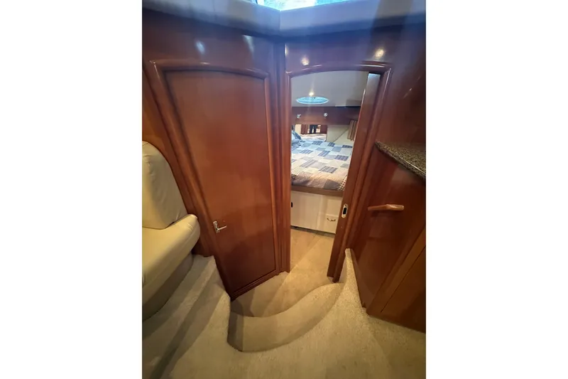 Slide: The Image of Interior of 2005 Carver 41 Cockpit Motor Yacht, featuring cozy cabin and wooden finishes. - 8