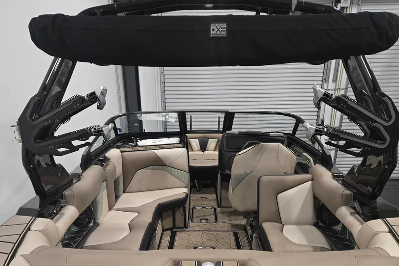 Slide: The Image of 2023 Centurion Fi23 boat interior with beige seating and black accents. - 11