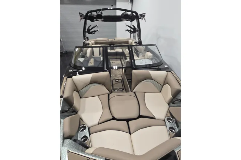Slide: The Image of 2023 Centurion Fi23 boat interior with beige and gray seating, featuring cup holders and a sleek design. - 12