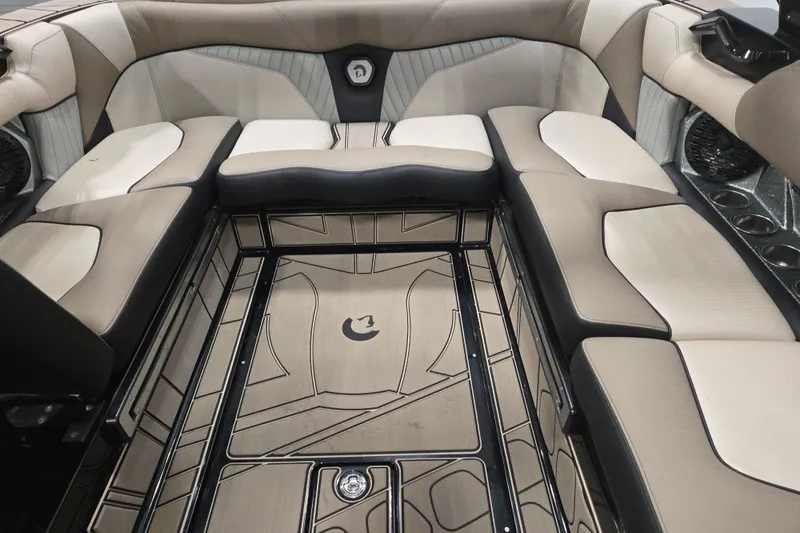 Slide: The Image of 2023 Centurion Fi23 boat interior with beige and black seating, stylish flooring design. - 8