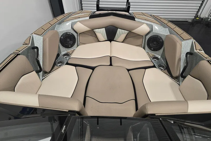 Slide: The Image of 2023 Centurion Fi23 boat interior with beige seating, cup holders, and speakers. - 9