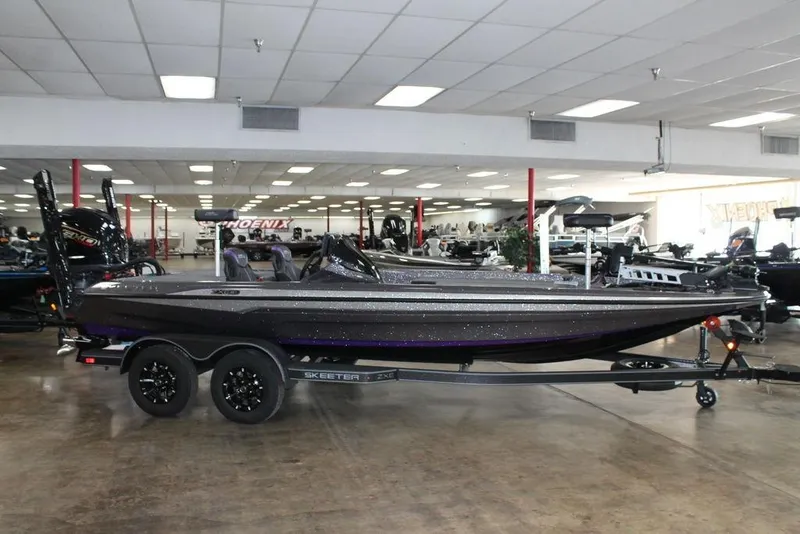 Slide: The Image of 2026 Skeeter ZXE21 boat displayed indoors on a trailer. - 1