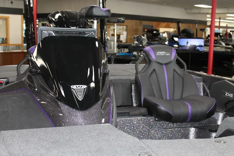 Slide: The Image of 2026 Skeeter ZXE21 boat interior with sleek black and purple seating design. - 6