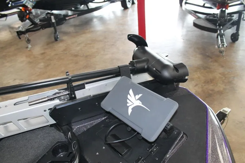 Slide: The Image of 2026 Skeeter ZXE21 boat with advanced control panel and sleek design in showroom. - 7