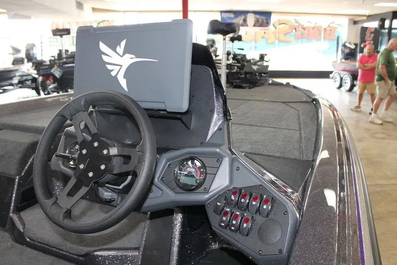 Slide: The Image of 2026 Skeeter ZXE21 boat dashboard with steering wheel and control panel. - 9