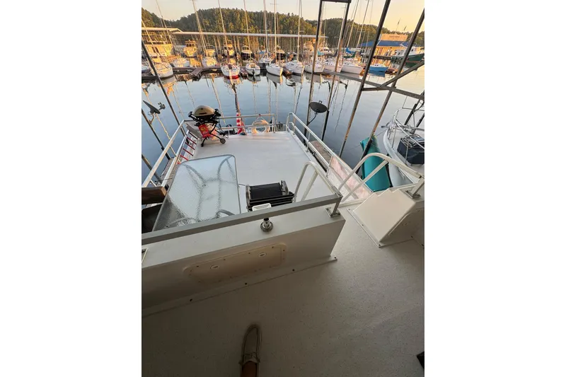 Slide: The Image of 1996 Gibson 50 Cabin Yacht docked at marina, featuring spacious deck and scenic water view. - 10