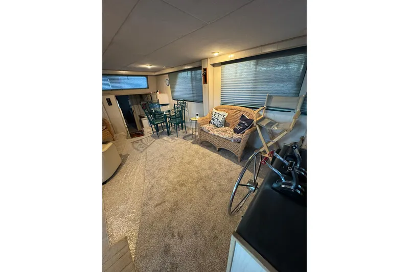 Slide: The Image of Interior of 1996 Gibson 50 Cabin Yacht with cozy seating and dining area. - 16