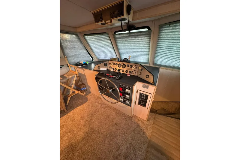 Slide: The Image of 1996 Gibson 50 Cabin Yacht helm with control panel and steering wheel. - 17